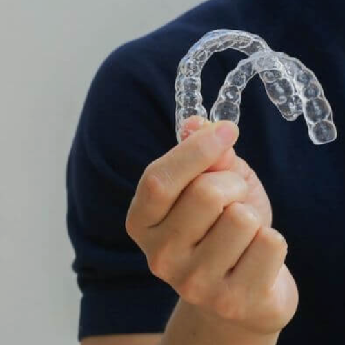 Man holding clear braces in Manchester