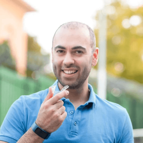 A man with invisalign aligners, clear braces