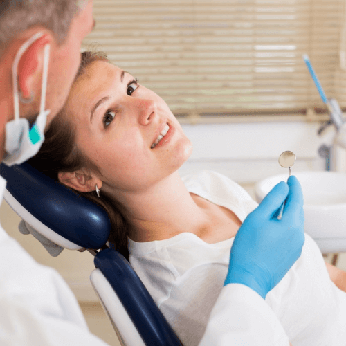 a woman sat in the dentists chair during her orthodontist consultation