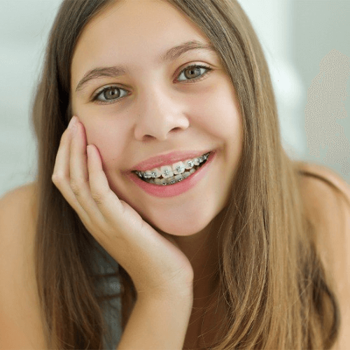 girl smiling with traditional metal braces
