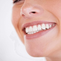 woman smiling with straight white teeth after invisalign