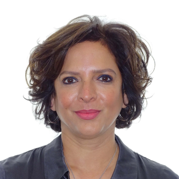 Dr. Tazeen Usmani at Heaton Mersey Orthodontic Centre, smiling towards the camera.