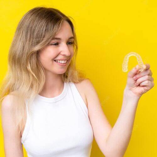 woman looking at her clear aligners