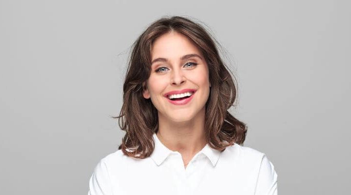 woman smiling with six month smiles clear braces