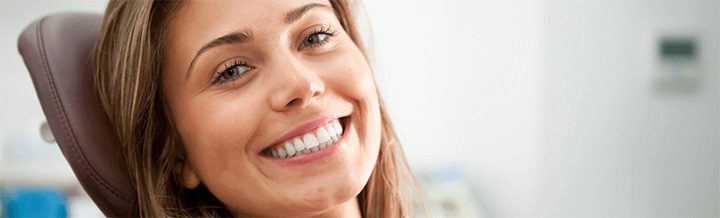 close up of woman in dental chair smiling during clear braces consultation in Stockport, manchester