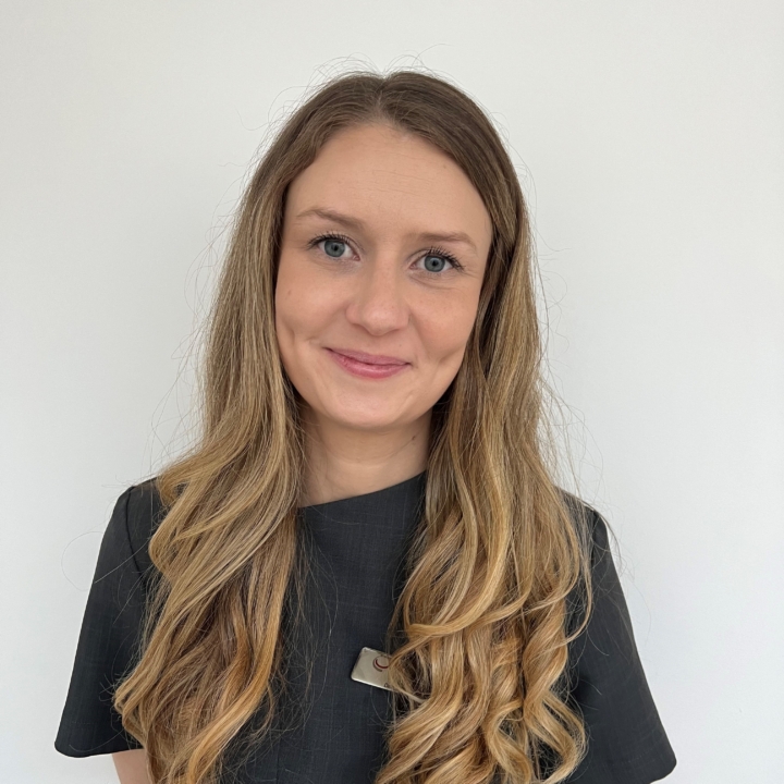 Laura, a dental nurse at Heaton Mersey Orthodontic Centre, smiling towards the camera.