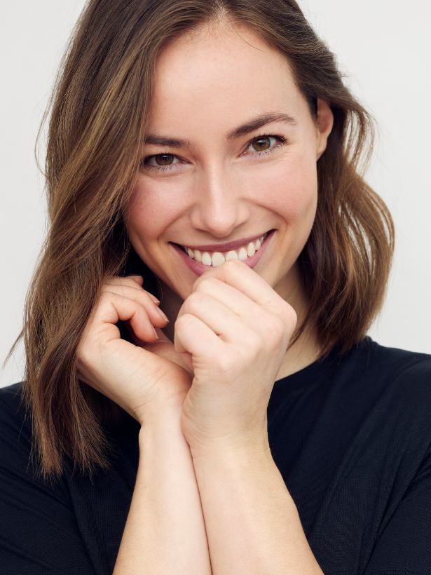 woman with a perfect smile after having Carriere braces in Manchester