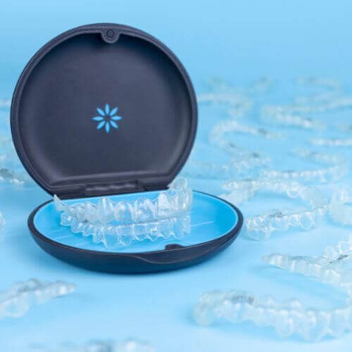 Image of a clean invisalign tray with blue background (Invisalign in Manchester and stockport)