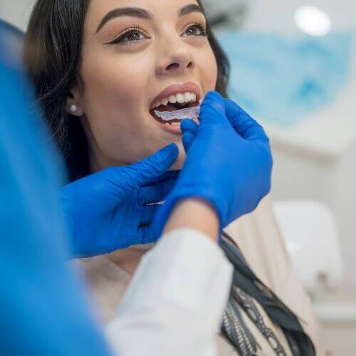 woman getting an orthodontic checkup for invisalign in manchester