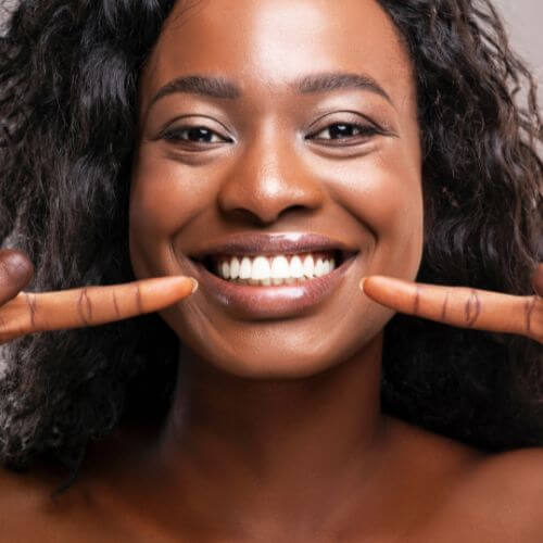 Close-up of a person's teeth showing a straight smile after reverse bite treatment.