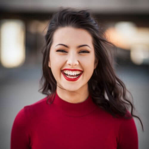 Lady smiling after getting ceramic braces in Manchester